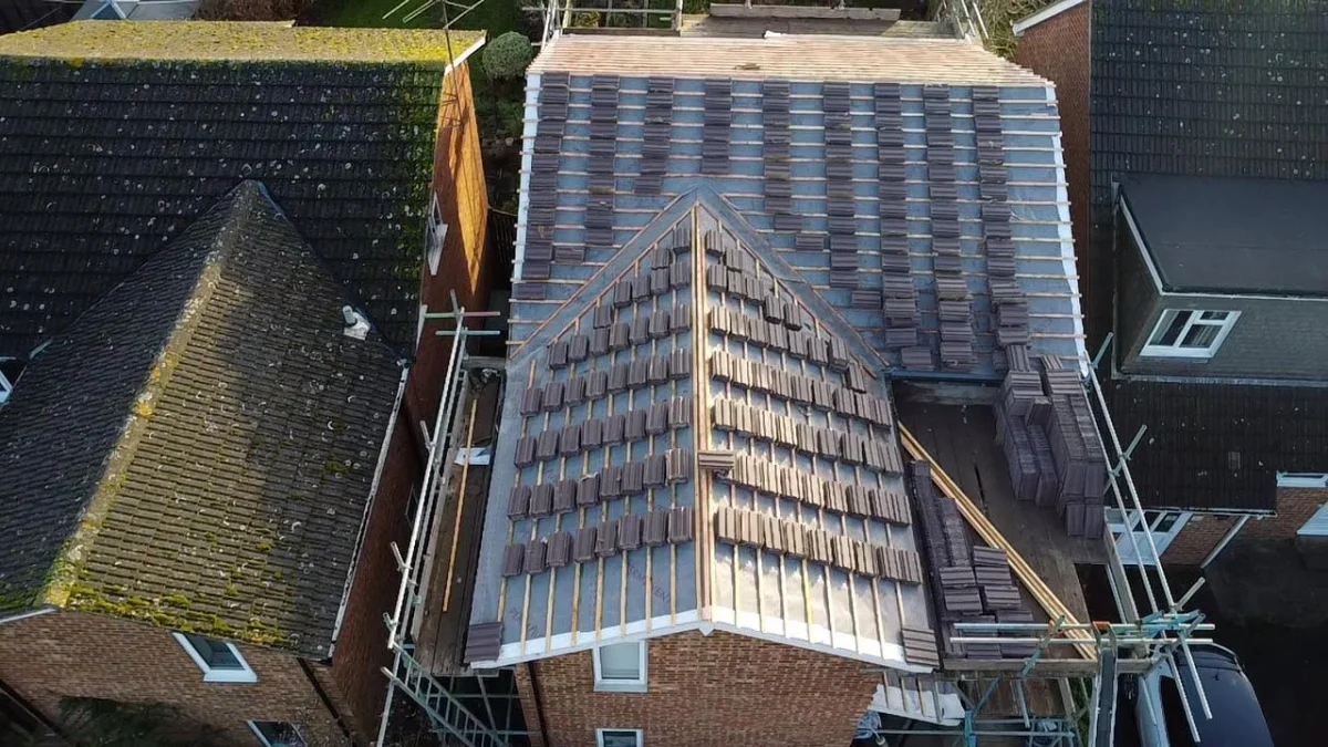 Pitched roof being re-tiled with scaffolding by Kingsway Roofing